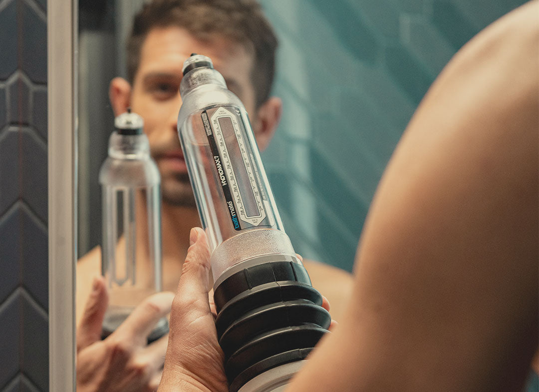 Man in shower holding hydro7 pump